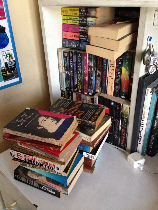 More books to keep (pile) and books to read (shelved)